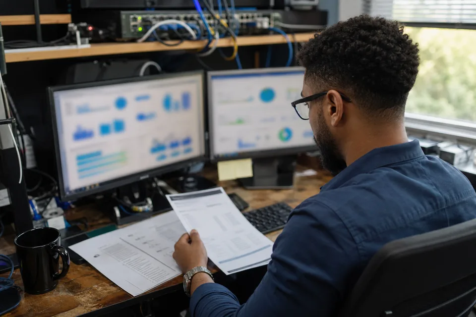 IT manager at a managed services desk comparing a monthly software invoice with a framework checklist