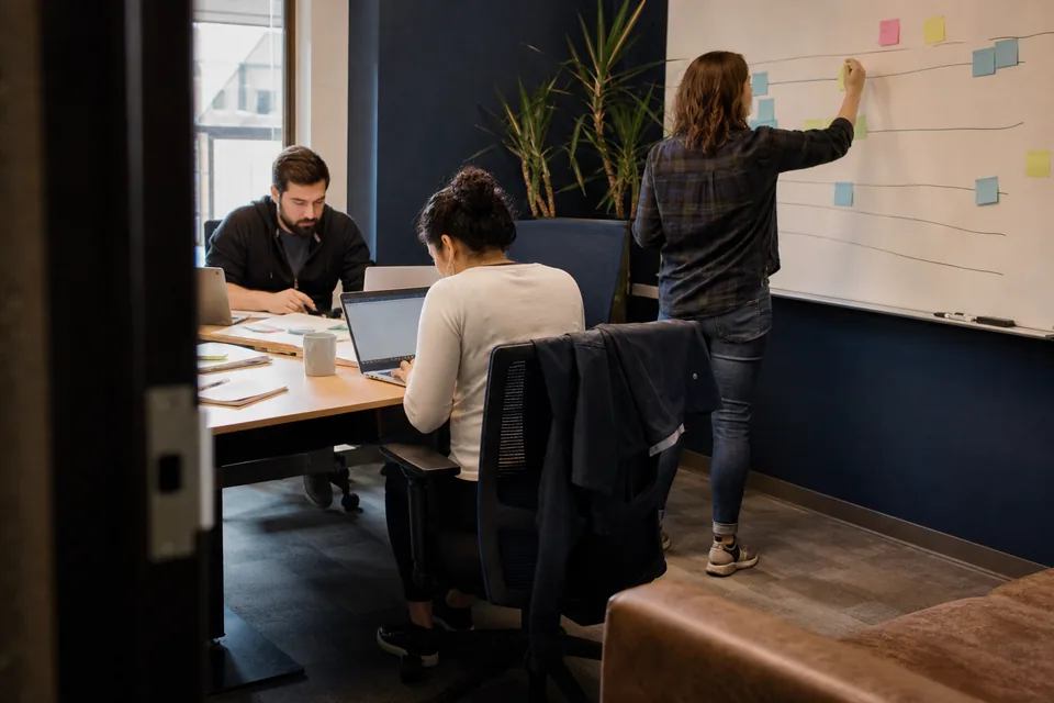 Project team planning a risk software implementation timeline in a meeting room